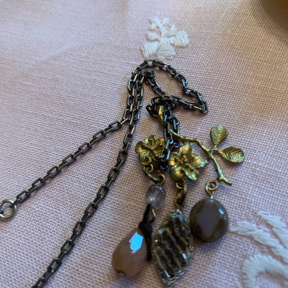 Gold tone charm necklace